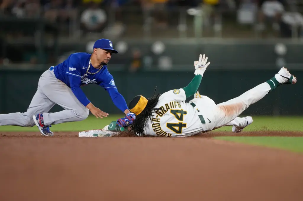 The Athletics’ Josh Kuroda-Grauer dives into second base with a...