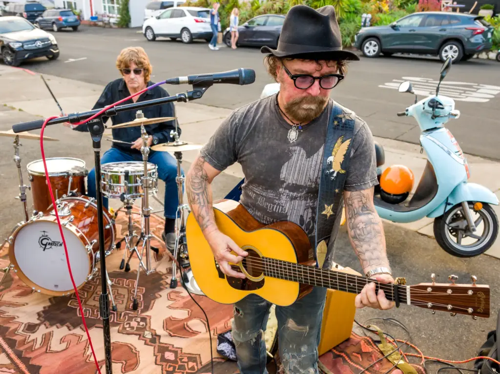 Christopher Amodeo, right, and Ray Weston perform during the ribbon-cutting...