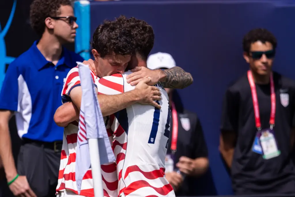 United States forward Christian Pulisic, center left, celebrates with midfielder...