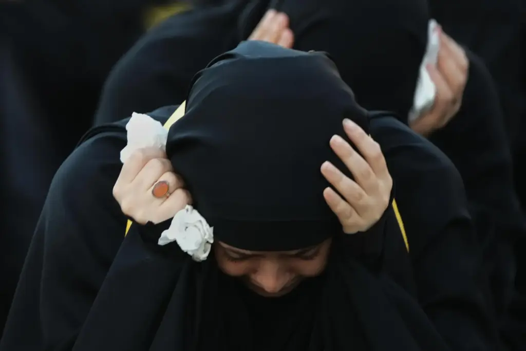 A woman mourns during a sermon marking the third day...