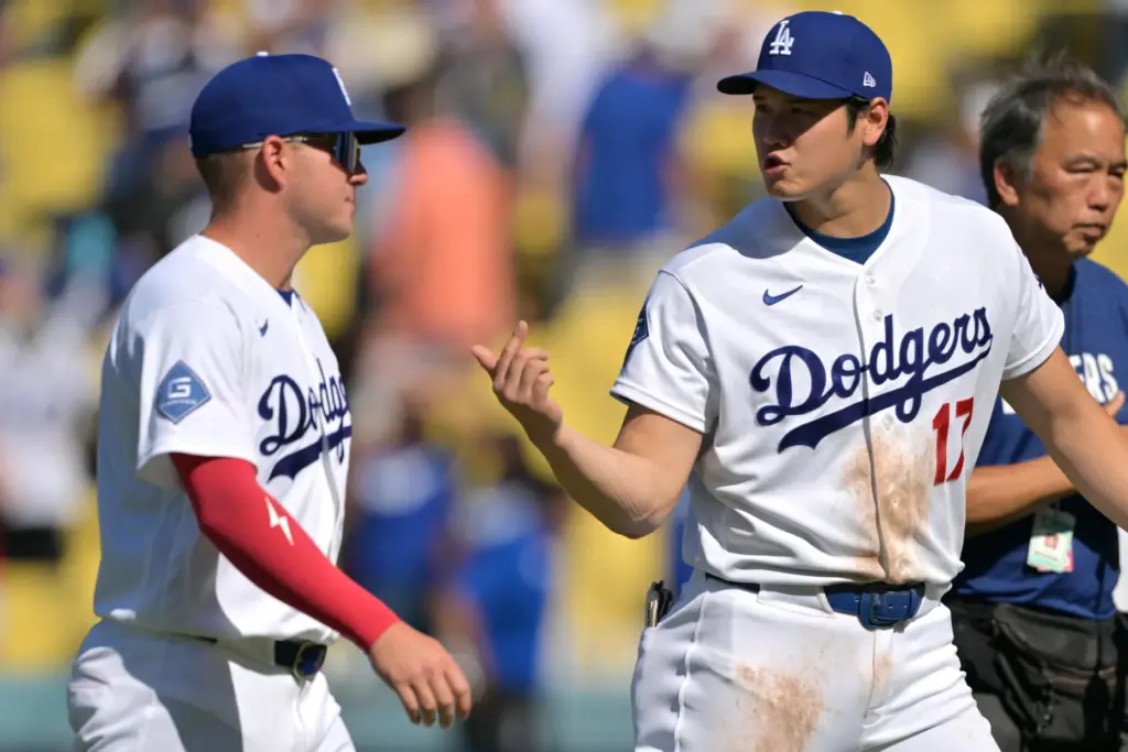 Dodgers’ Ryan Ward, left, talks with teammate Shohei Ohtani as...