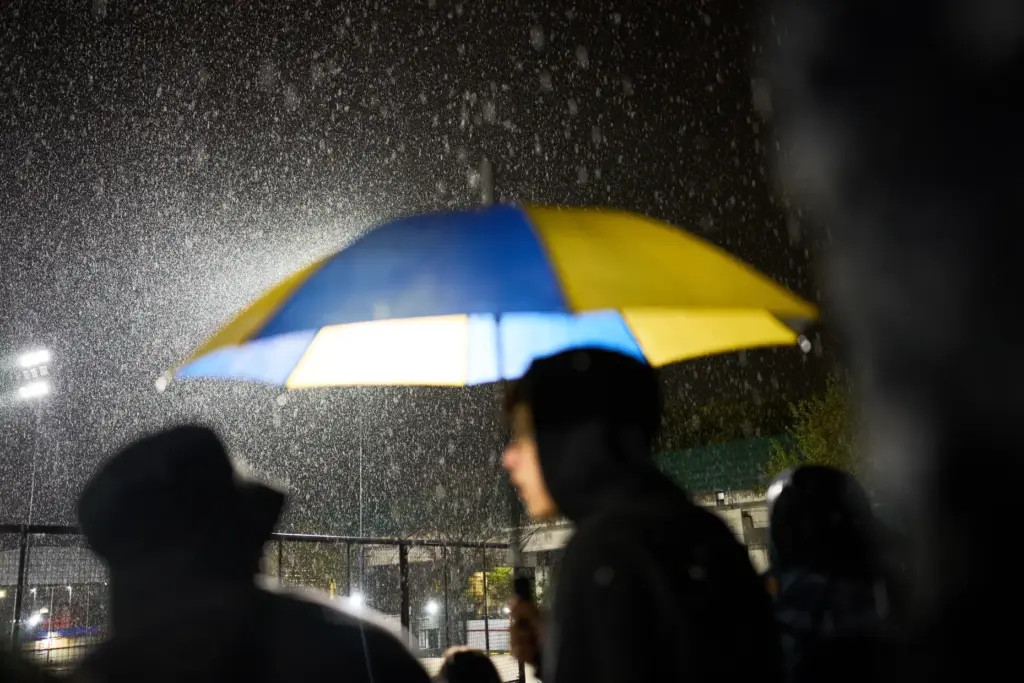 Atlanta fans stand under the rain during a match.