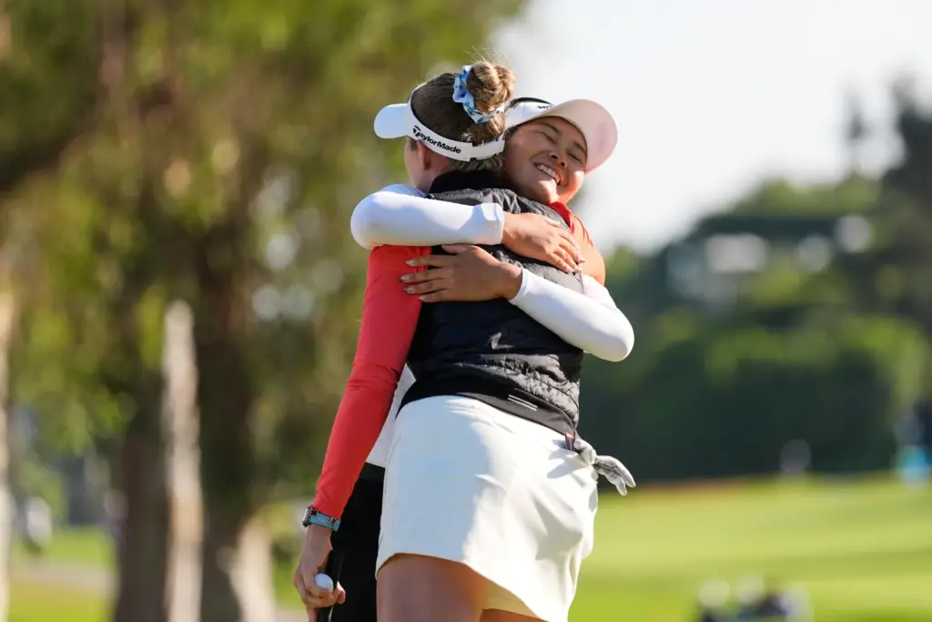 Sora Kamiya, of Japan, facing, hugs Nelly Korda after finishing...