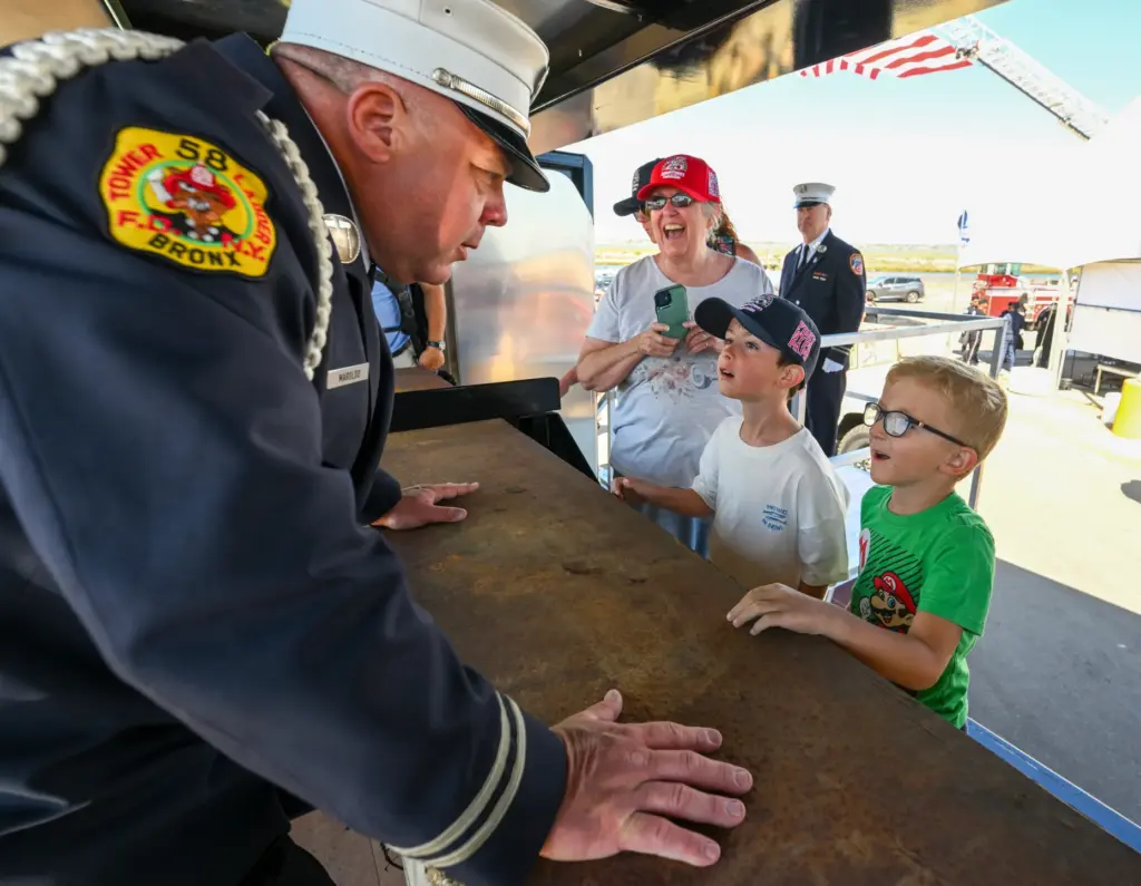 Retired NYFD firefighter Jimmy Maroldo jokingly asks Owen Benning, 9,...