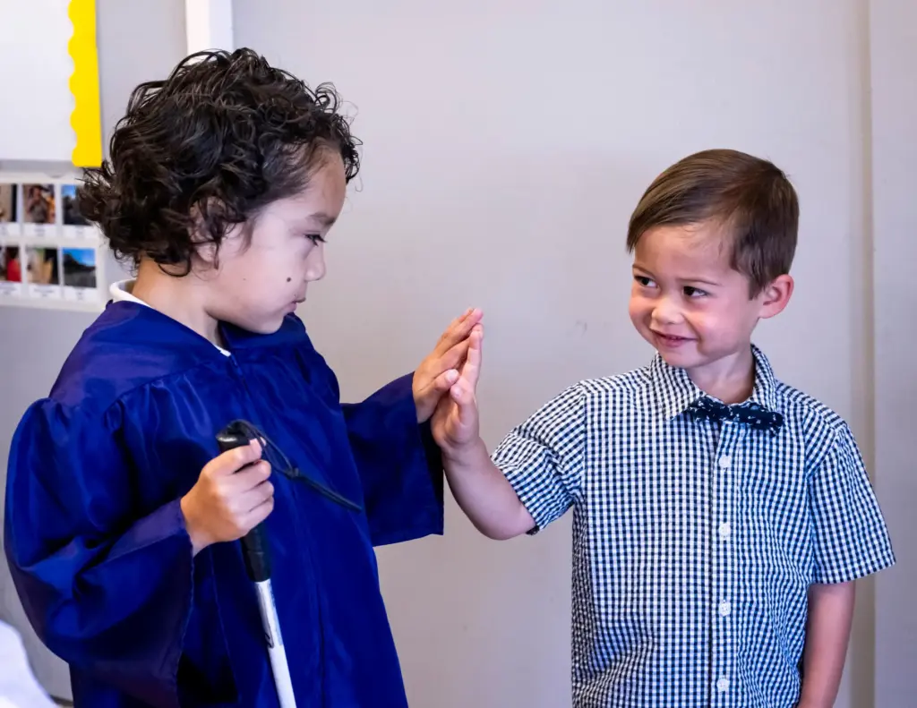 Liam Espinoza, who is visually impaired, and Dylan Oman, from...
