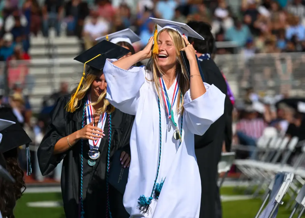 Graduate Sophia Dickson celebrates after getting her diploma during the...
