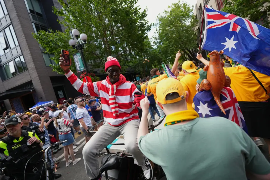 United States and Australia fans bump fists on their way...