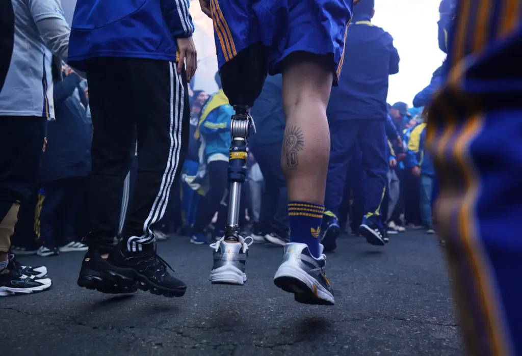 Ignacio Calle jumps with his prosthetic leg while singing Boca Juniors chants.