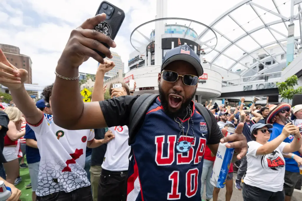 U.S.A. soccer fan Rolando Rhymes celebrates their second goal against...