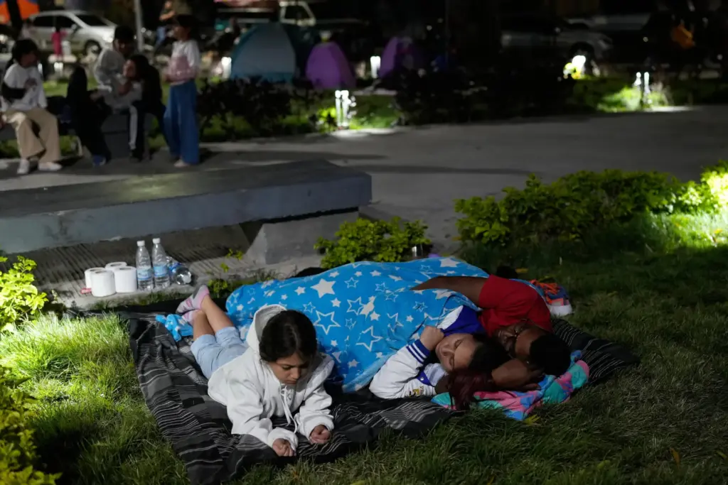 People camp out the night after earthquakes struck Caracas, Venezuela,...