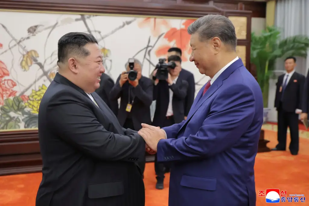 North Korean leader Kim Jong Un shakes hands with Chinese President Xi Jinping in Beijing.