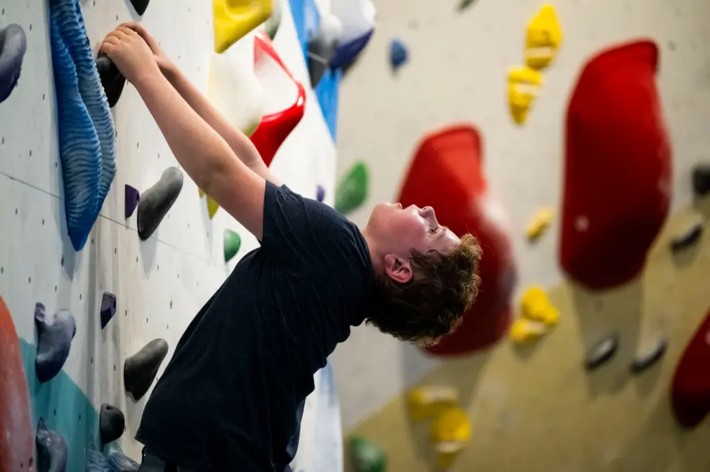 Alexander Rados, 11, takes a break on the boulder wall...