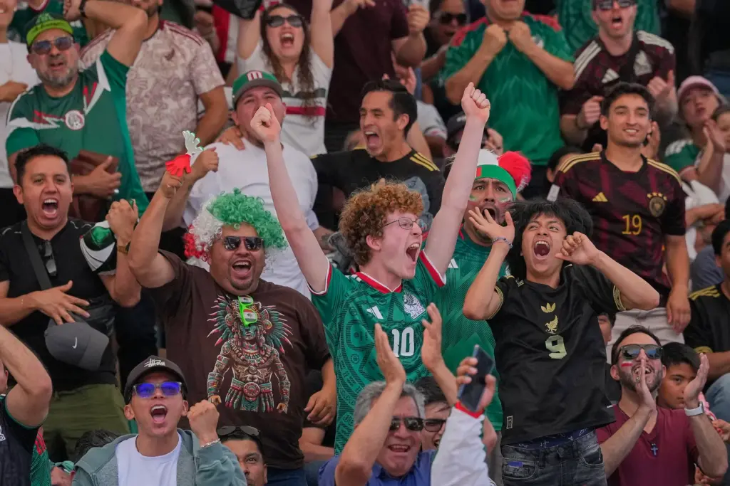 Mexico fans celebrate their team’s first goal against South Africa...