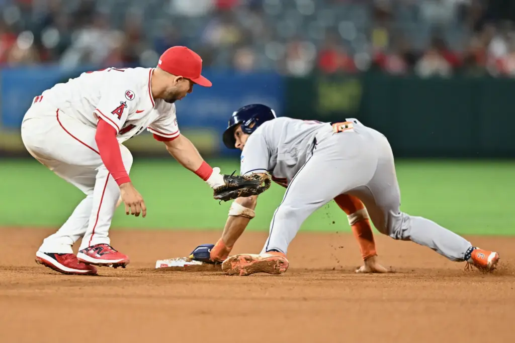 The Houston Astros’ Jeremy PeÃ±a, right, slides safely past Angels...