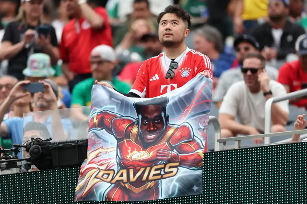 A Canada fan holds a banner before the start of...