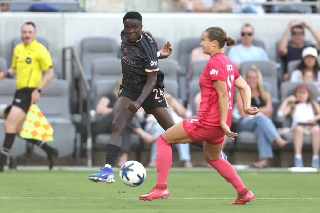 Angel City FC forward Prisca Chilufya, left, kicks the ball...