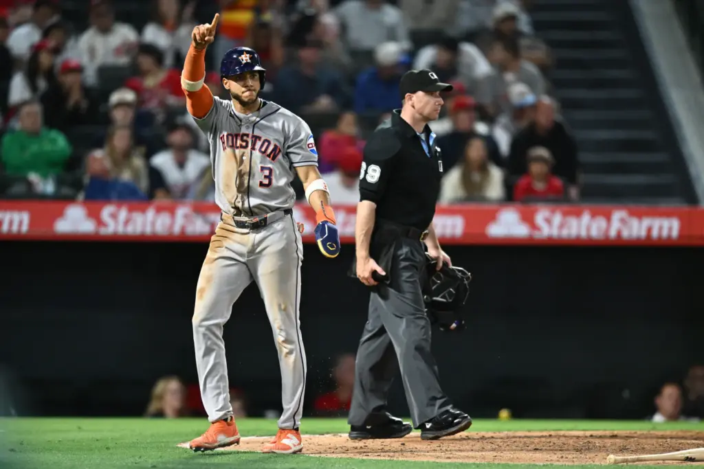 The Houston Astros’ Jeremy PeÃ±a, left, gestures after scoring the...
