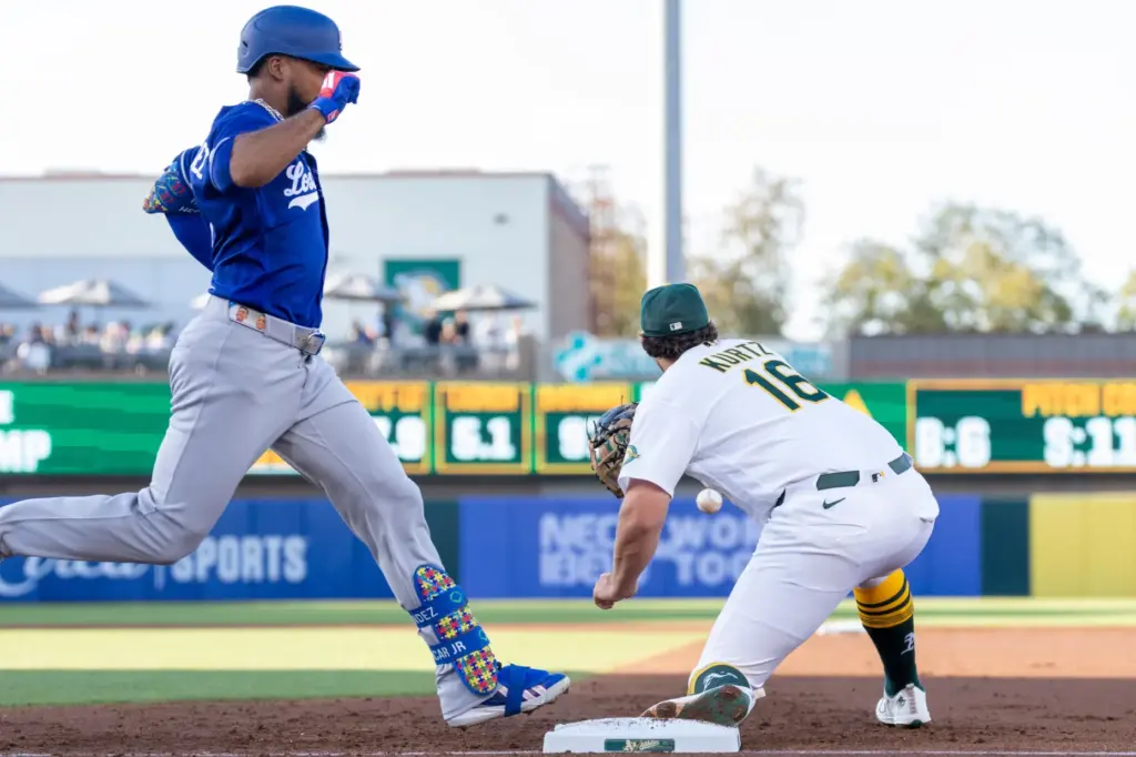 Athletics first baseman Nick Kurtz, right, attempts to catch the...