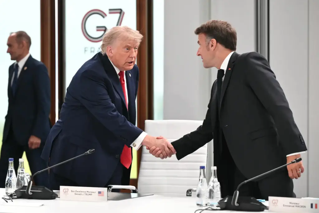 President Donald Trump shakes hands with France's President Emmanuel Macron.