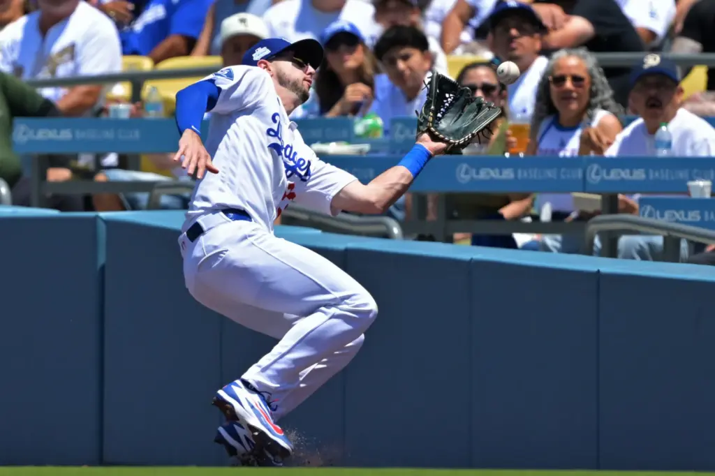 Dodgers right fielder Kyle Tucker cannot reach a pop foul...