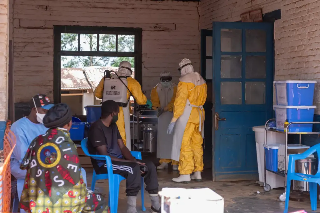 Health workers prepare for duty at the Mongbwalu treatment center in Congo.