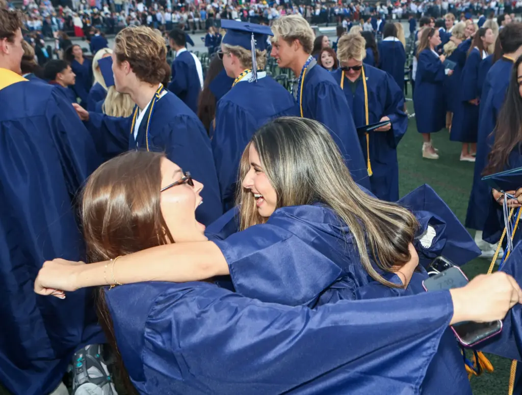 Graduates rush eachother after they graduated from Newport Harbor High...