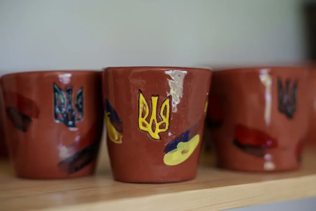 Clay cups decorated with Ukrainian triangle are seen inside apartments...