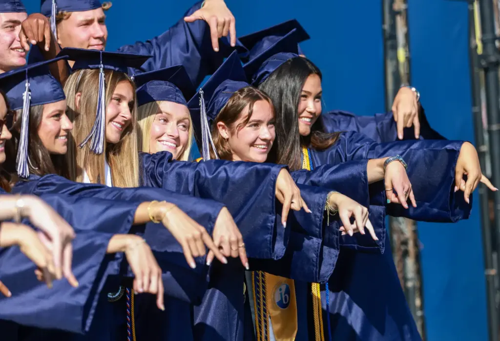 Graduates pose for photos prior to graduating from Newport Harbor...