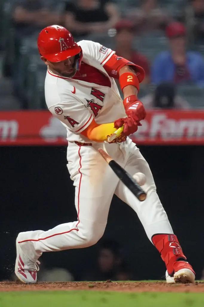 The Angels’ Oswald Peraza breaks his bat while hitting an...