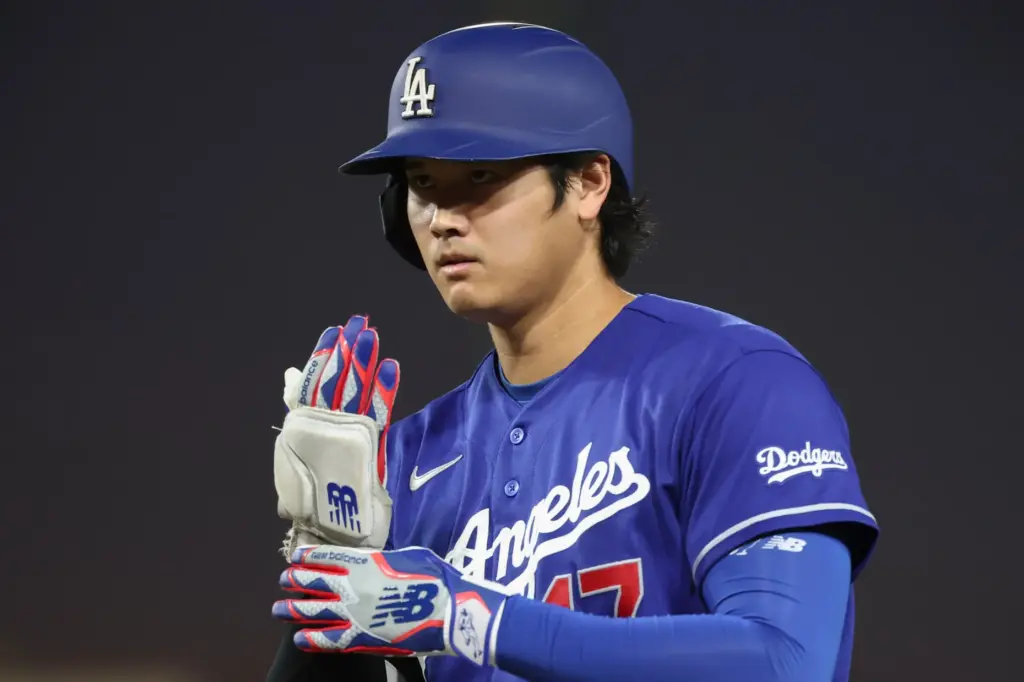 Dodgers star Shohei Ohtani puts on his sliding mitt after...