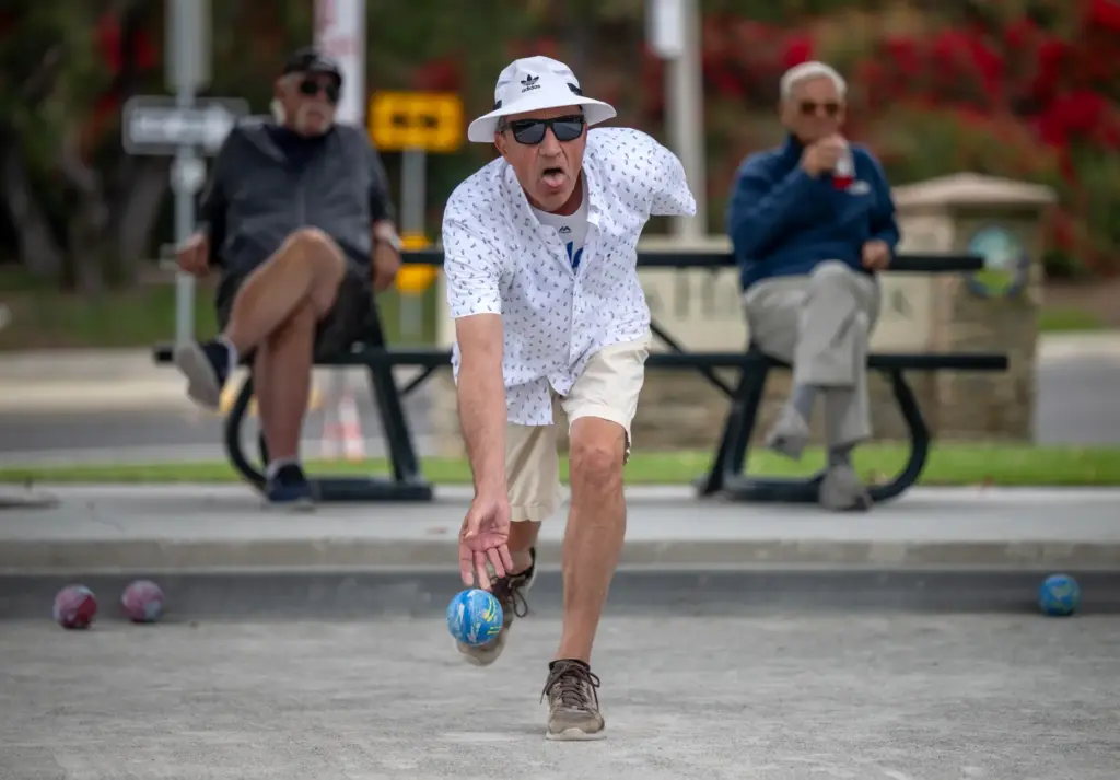 Steve Cryan of Mission Viejo rolls a bocce ball while...
