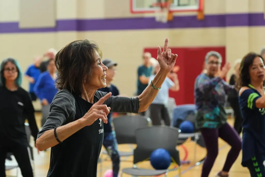 Instructor Bengie Santos, 72, leads a class for older adults.