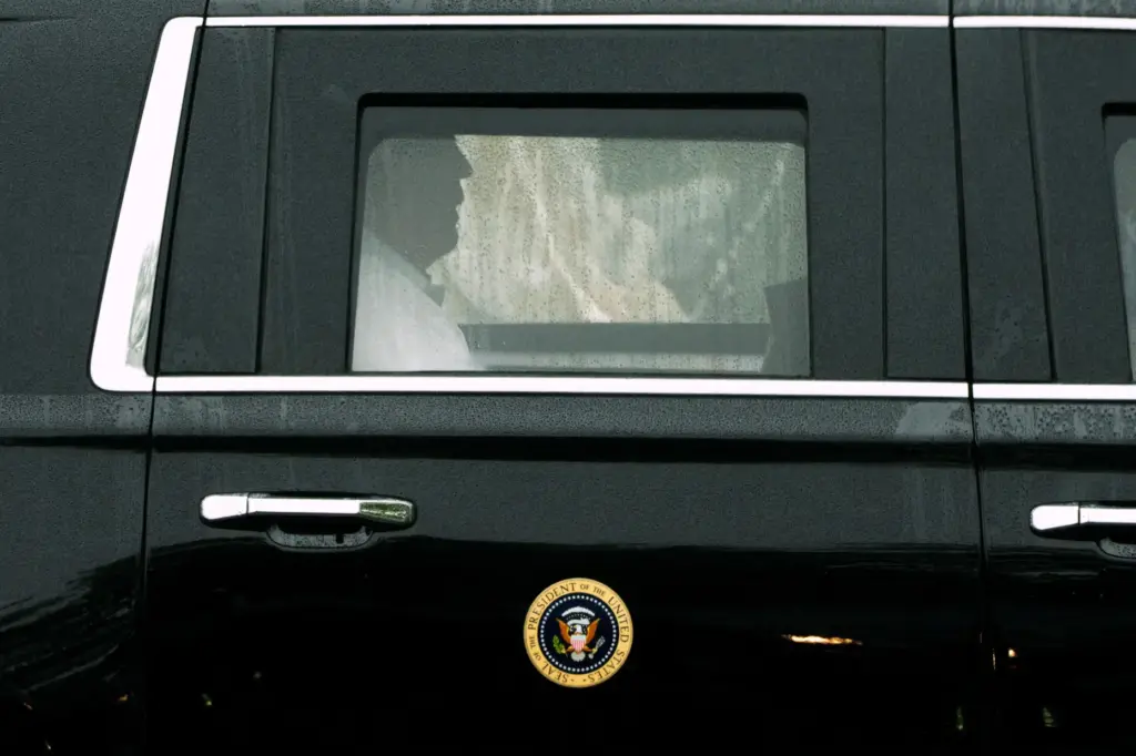 President Donald Trump rides in his limousine as he leaves...