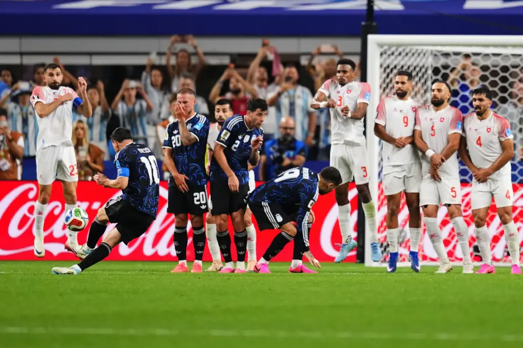 Argentina’s Lionel Messi, second from left, scores his side’s third...