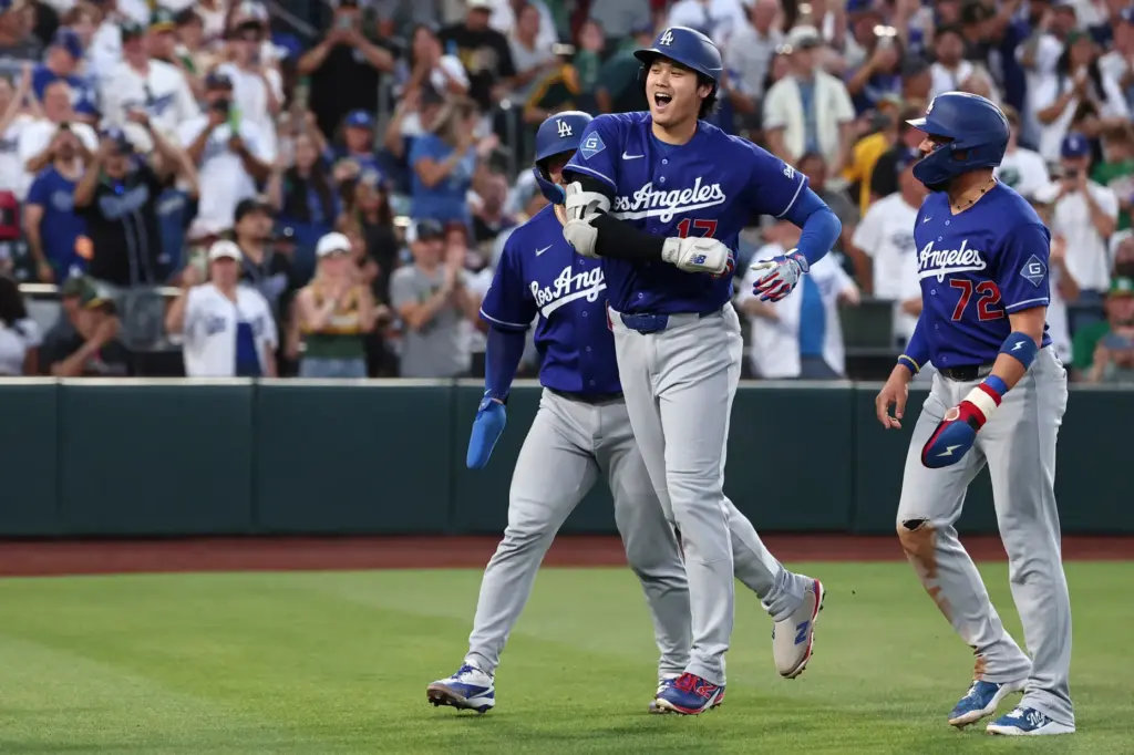 Dodgers star Shohei Ohtani celebrates after hitting a three-run home...
