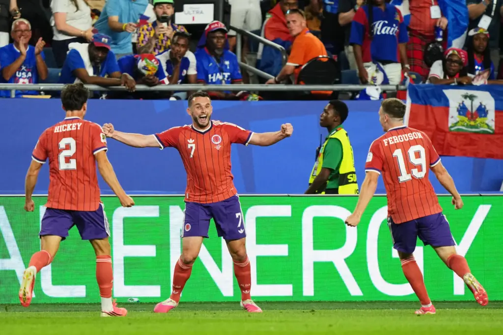 Scotland’s John McGinn (7) celebrates with teammate’s Aaron Hickey (2)...