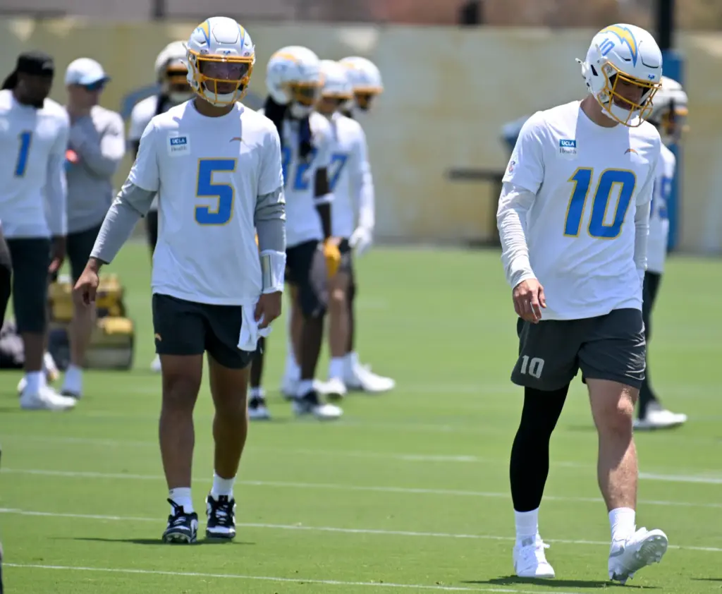 Chargers quarterbacks Justin Herbert (10) and Trey Lance (5) participate...
