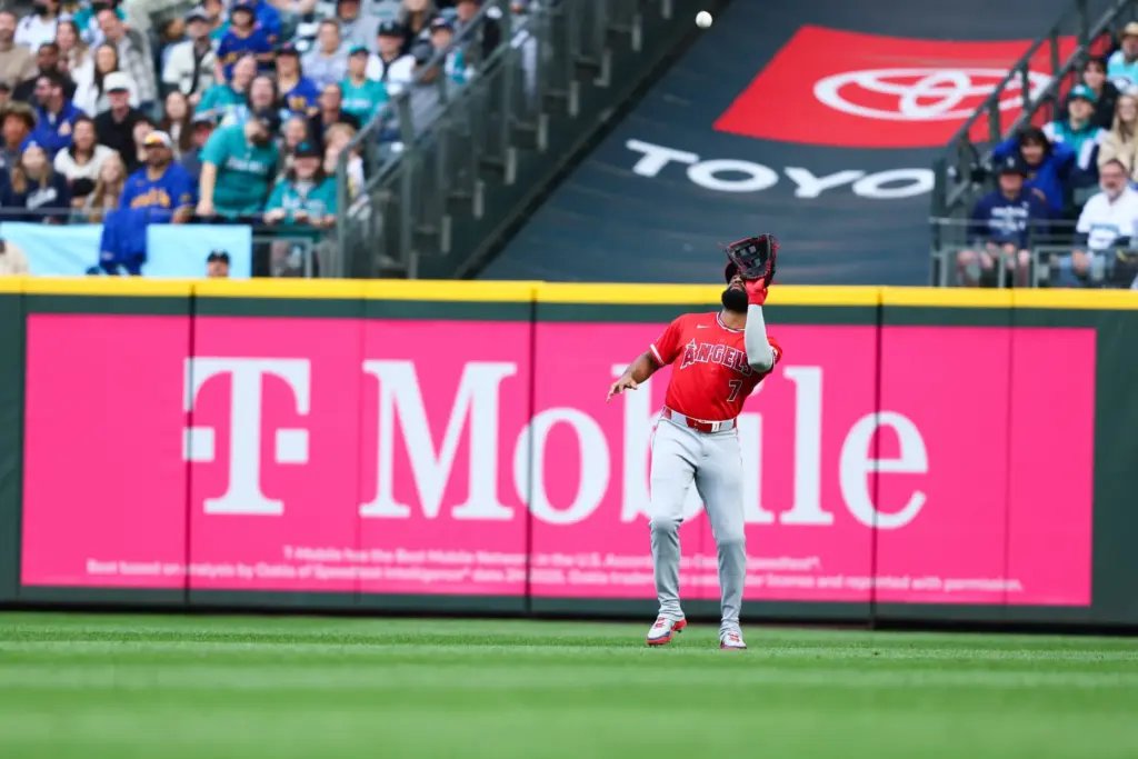 Angels outfielder Jo Adell catches a pop fly hit by...