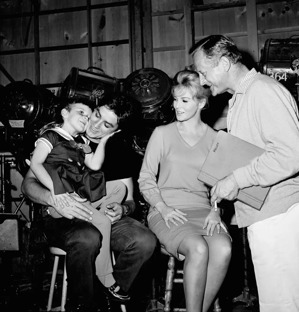 Actor Alain Delon gets hug from little Tammy Locke, who...