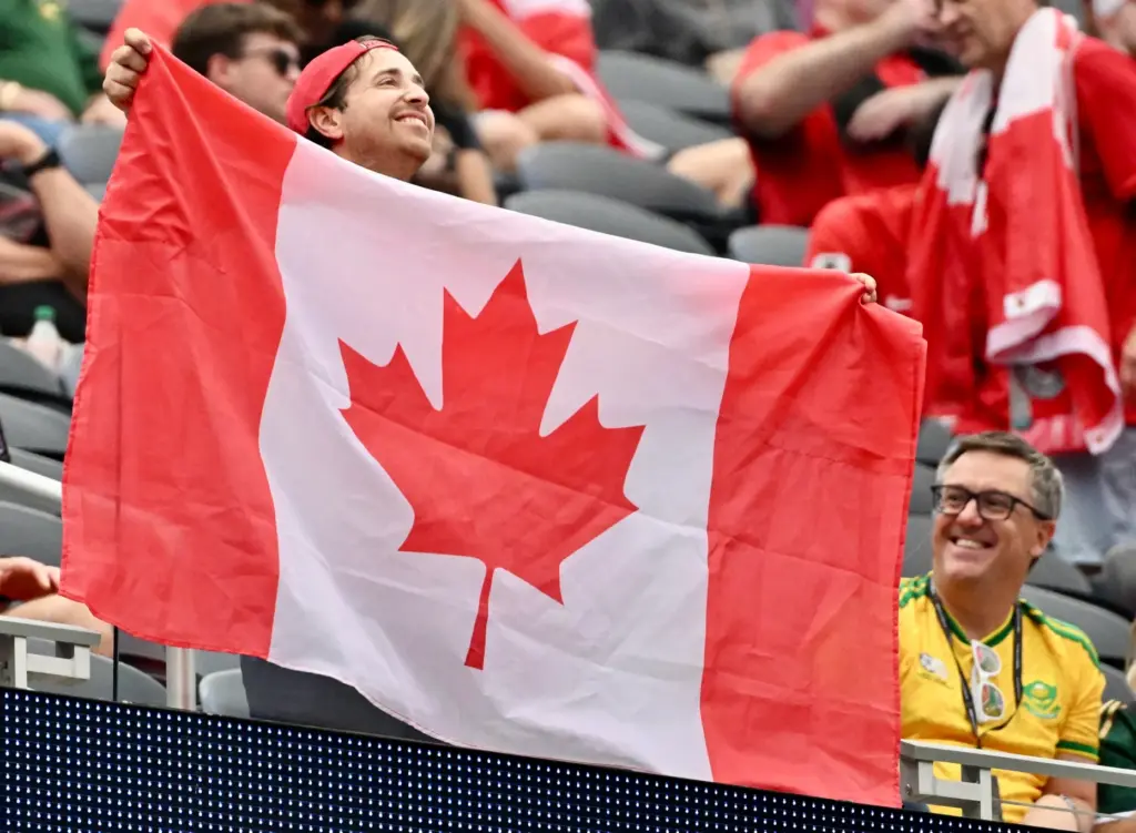 A Canadian fan waves the flag prior to a FIFA...