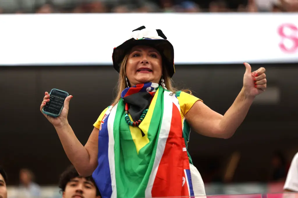 A South Africa fan dances before the start of a...