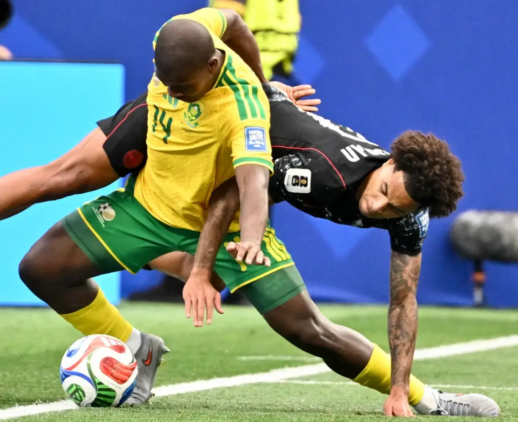 South Africa defender Mbekezeli Mbokazi (14) fights for the ball...