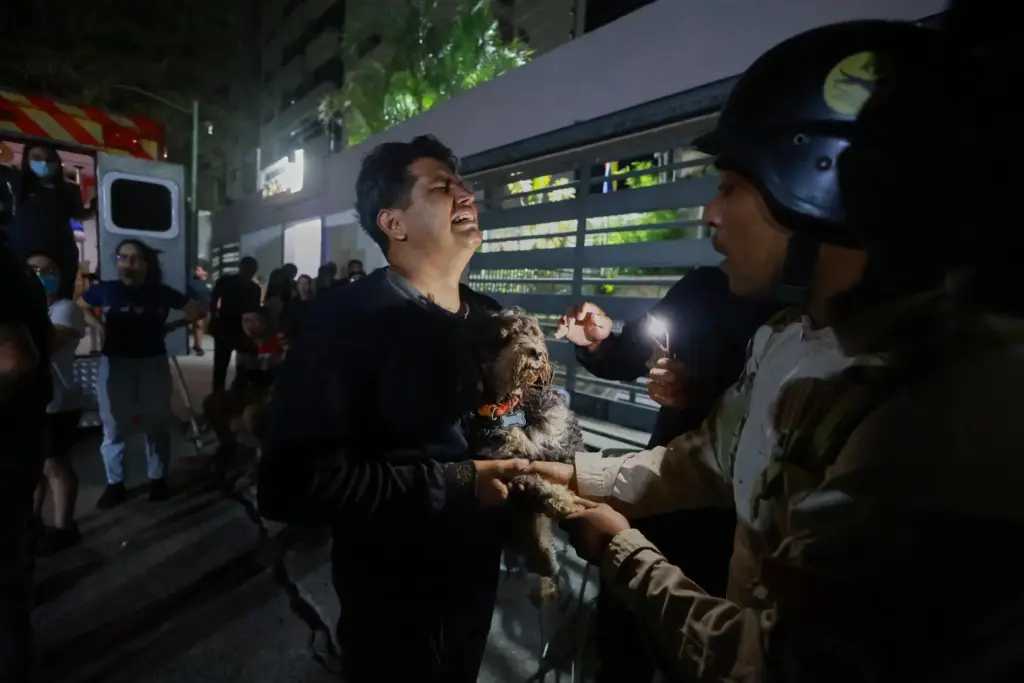 A man holding a dog cries after an earthquake in Caracas, Venezuela.
