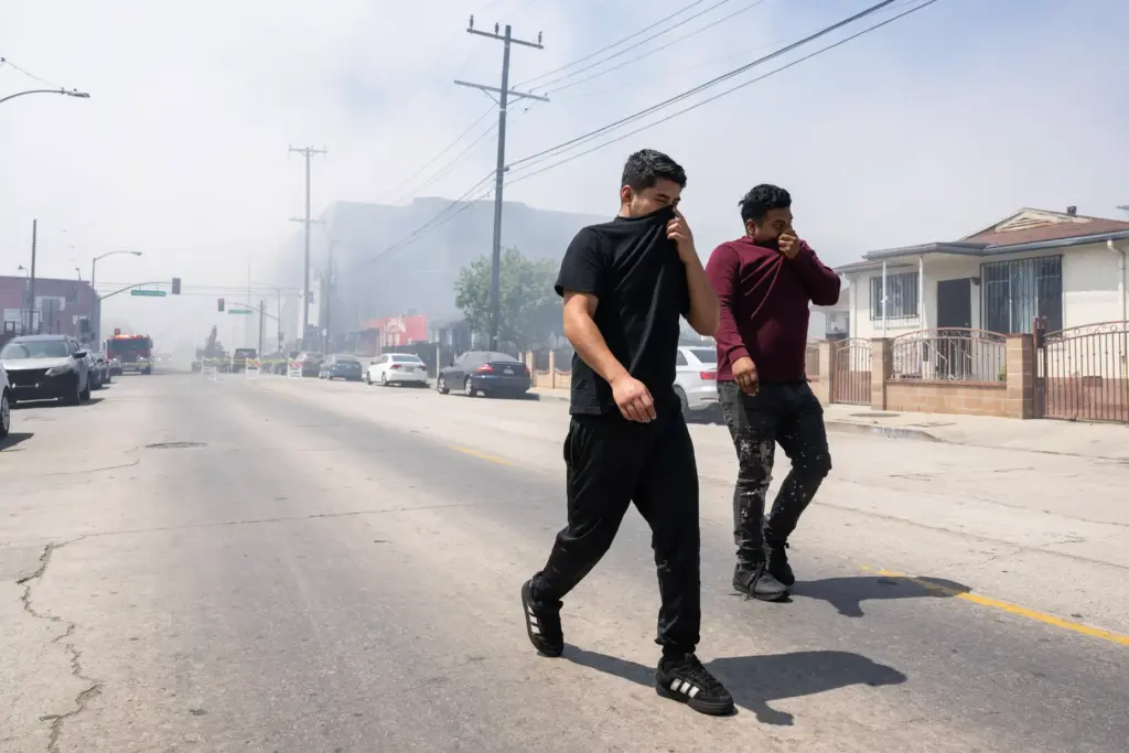 From left, Fernando Perez and Antonio Perez cover their faces...