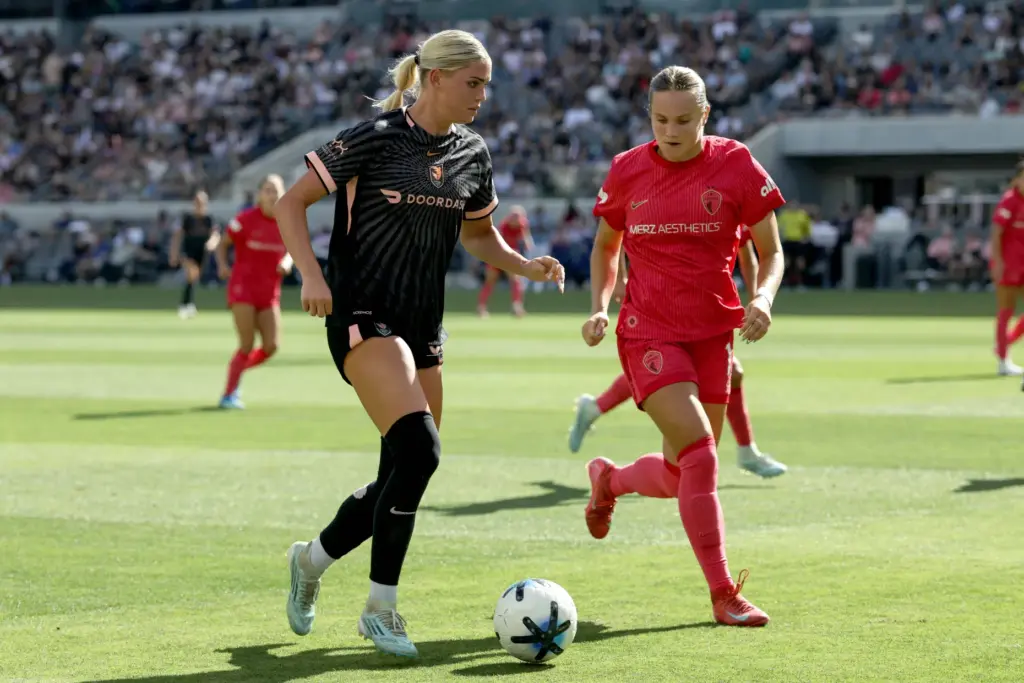 Angel City FC forward Riley Tiernan, left, moves the ball...