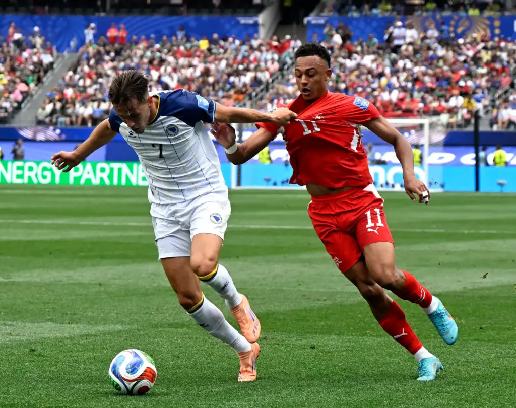 Bosnia and Herzegovina defender Amar DediÄ (7) pulls on Switzerland...