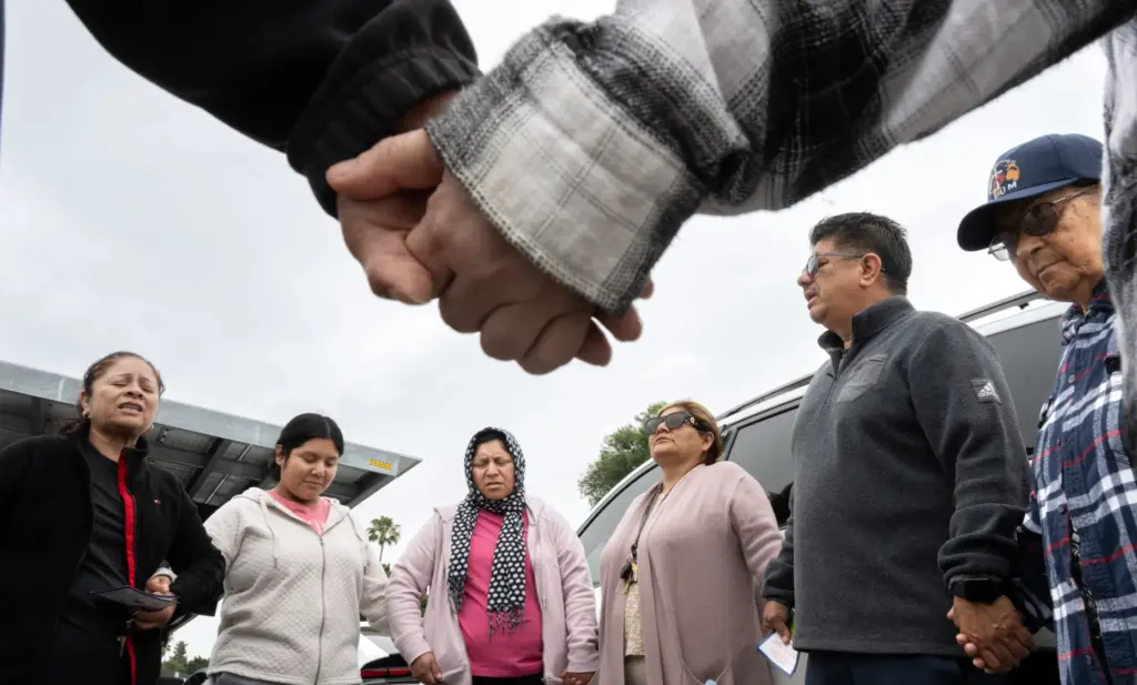 Members of Christ Breaks Chains church pray outside Savanna High...