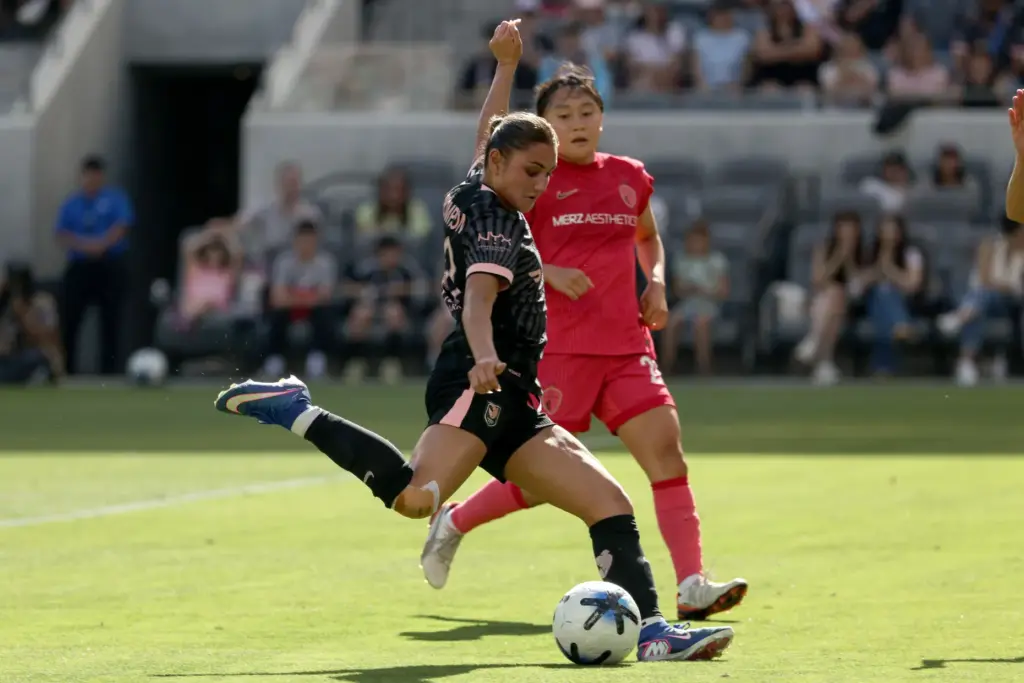 Angel City FC defender Gisele Thompson, front, winds up to...