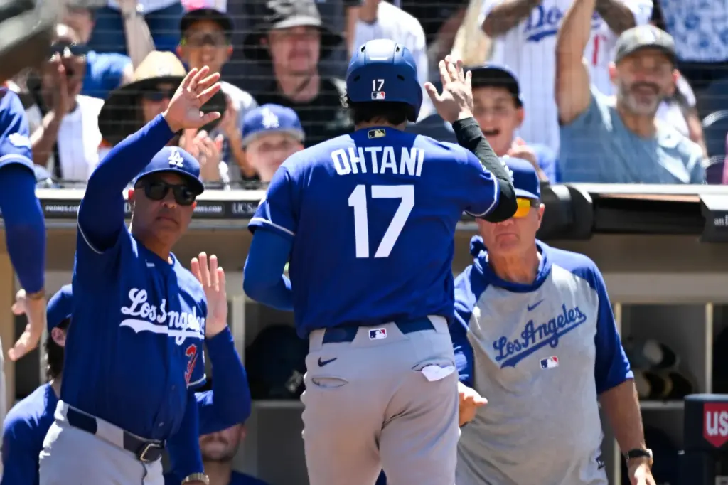 Dodgers designated hitter Shohei Ohtani (17) is welcomed into the...