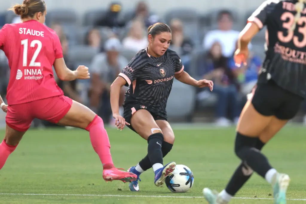 Angel City FC defender Gisele Thompson, center, kicks the ball...
